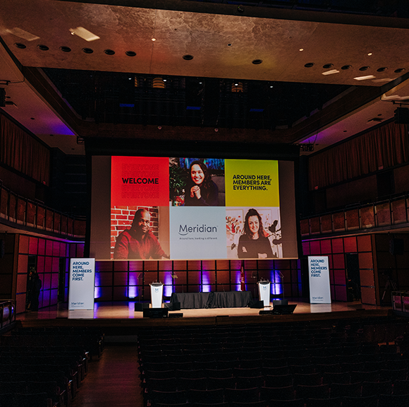 Meridian Member, A teenage girl in bright colored summer clothing smiling to the camera.