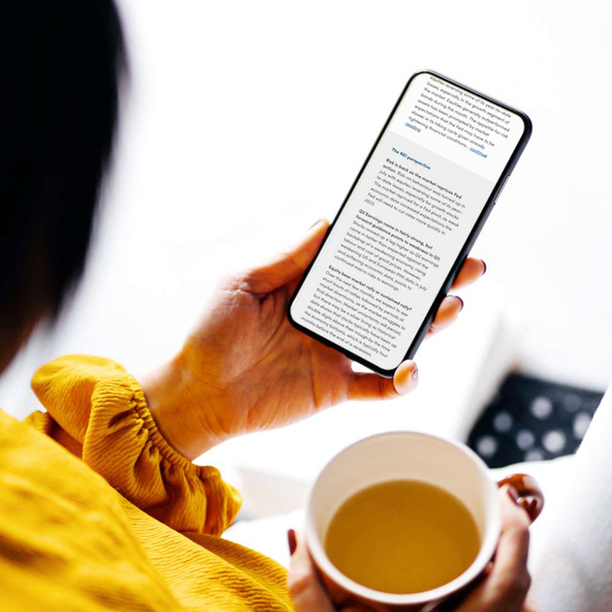 Person holding mobile phone, looking at financial information