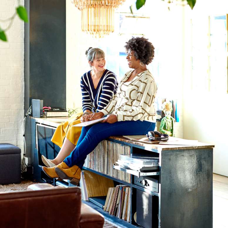 Two women sitting together and laughing