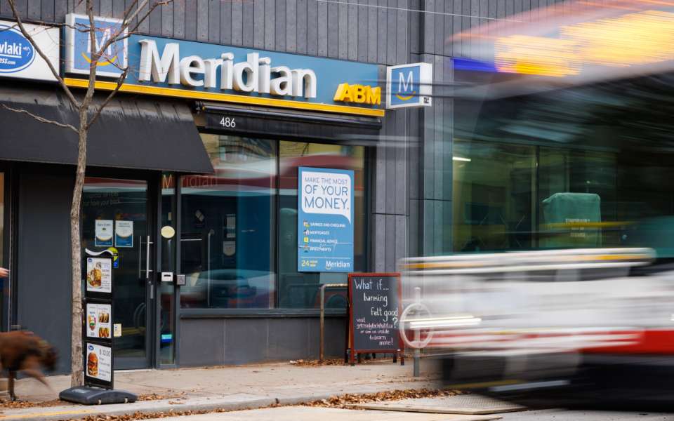 Meridian branch exterior with a blurry Toronto Transit bus driving by