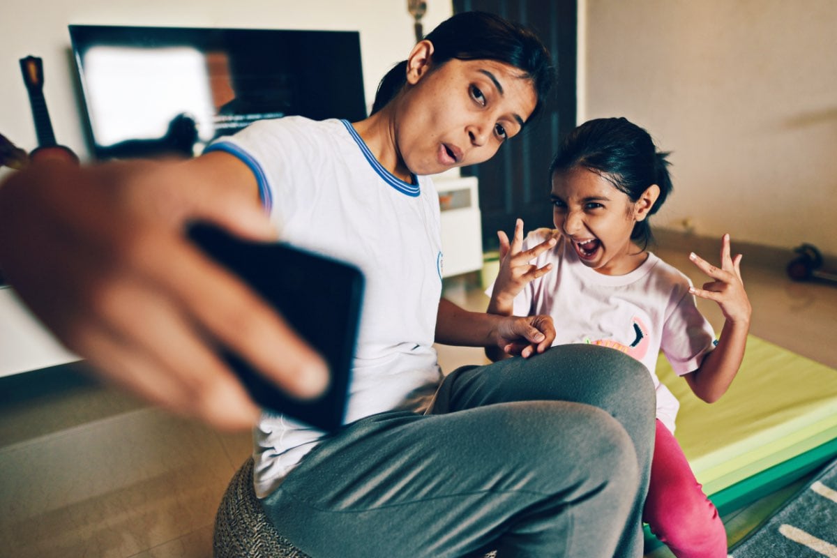 mother and daughter taking a funny selfie
