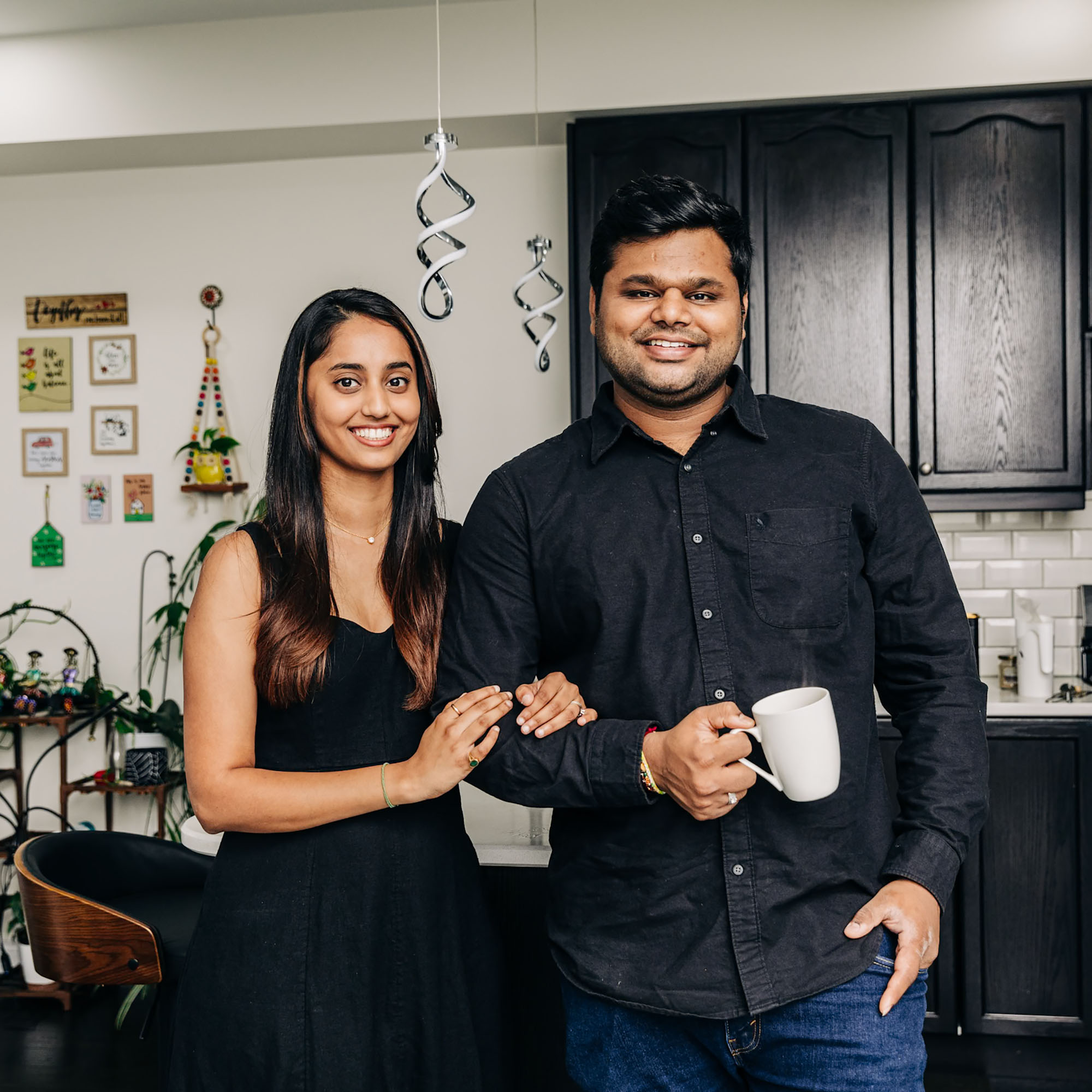 Two Meridian Members, a young couple, standing in their kitchen