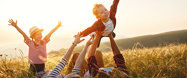kids playing with parents in a field