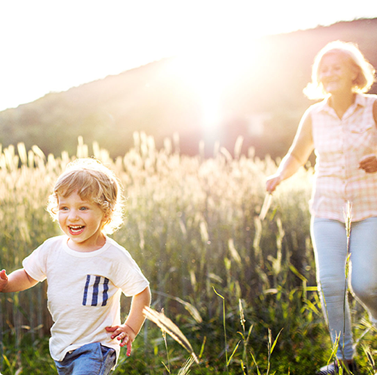 Sunny day, child running through the grass