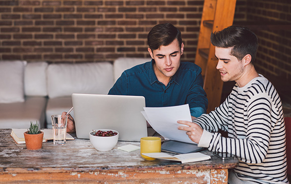 couple looking at paperwork at kitchen table