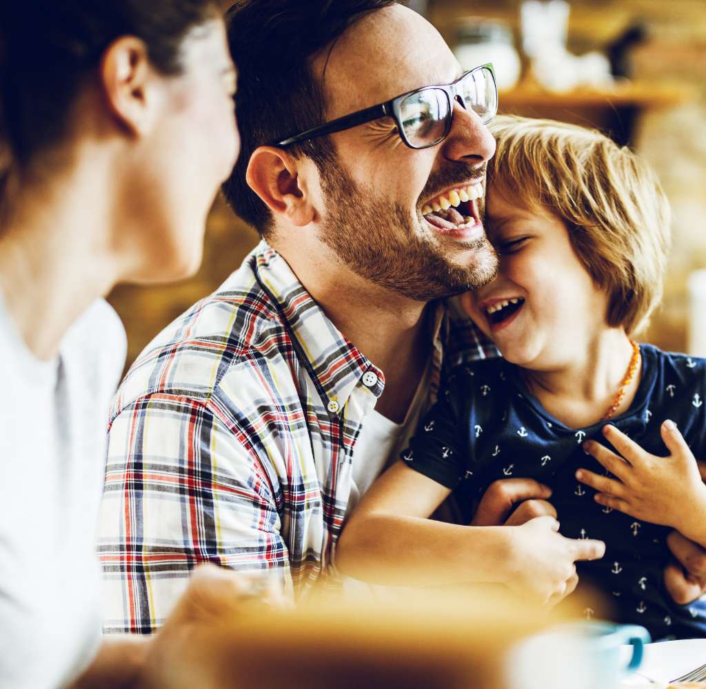 Laughing family sitting together
