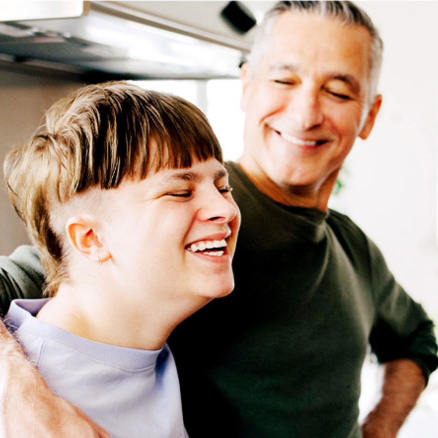 Father smiling with his arm around his son