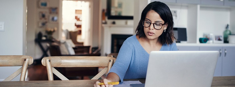 Women sitting at her laptop doing calculations