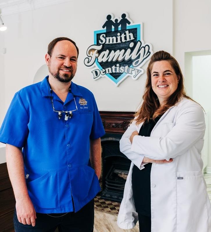 Two dental professionals from Smith Family Dentistry at their place of business. 