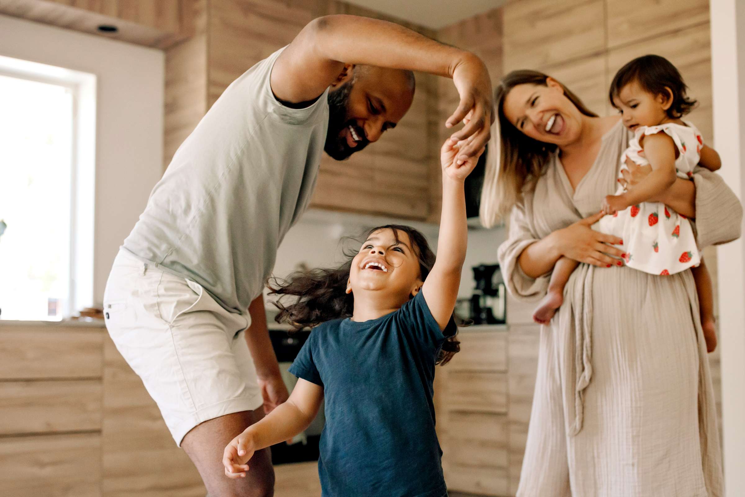 A family with two children are enjoying a good time at their home.