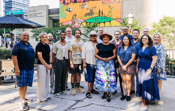 A group of Meridian employees and partners gather outside on a sunny day in Toronto. 