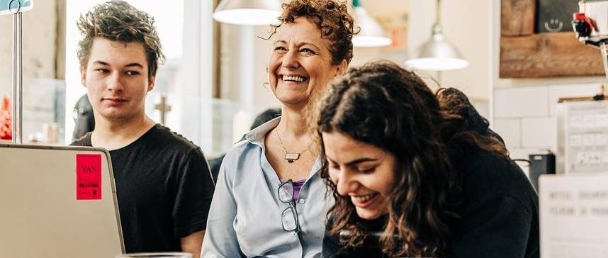 A small group of people gather and share a laugh at the 541 Eatery.