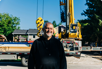 Rob C. standing outside in a construction yard.