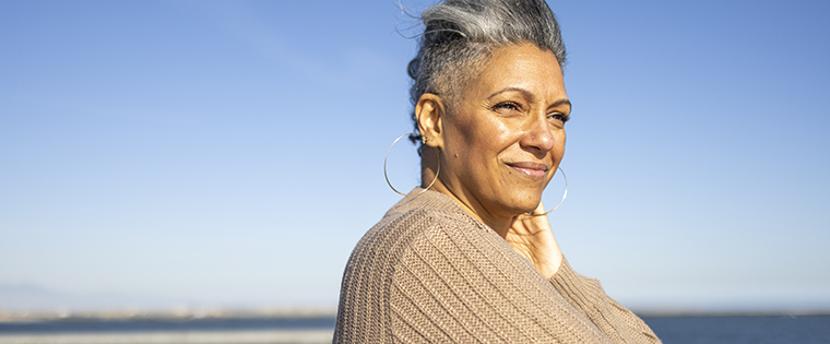 Mature black woman relaxing at the pier