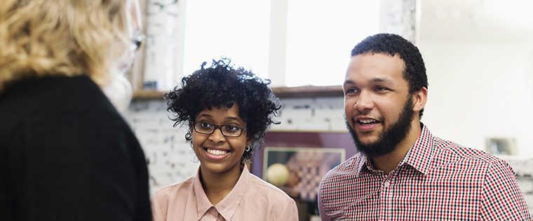 Businesswoman talking to young couple