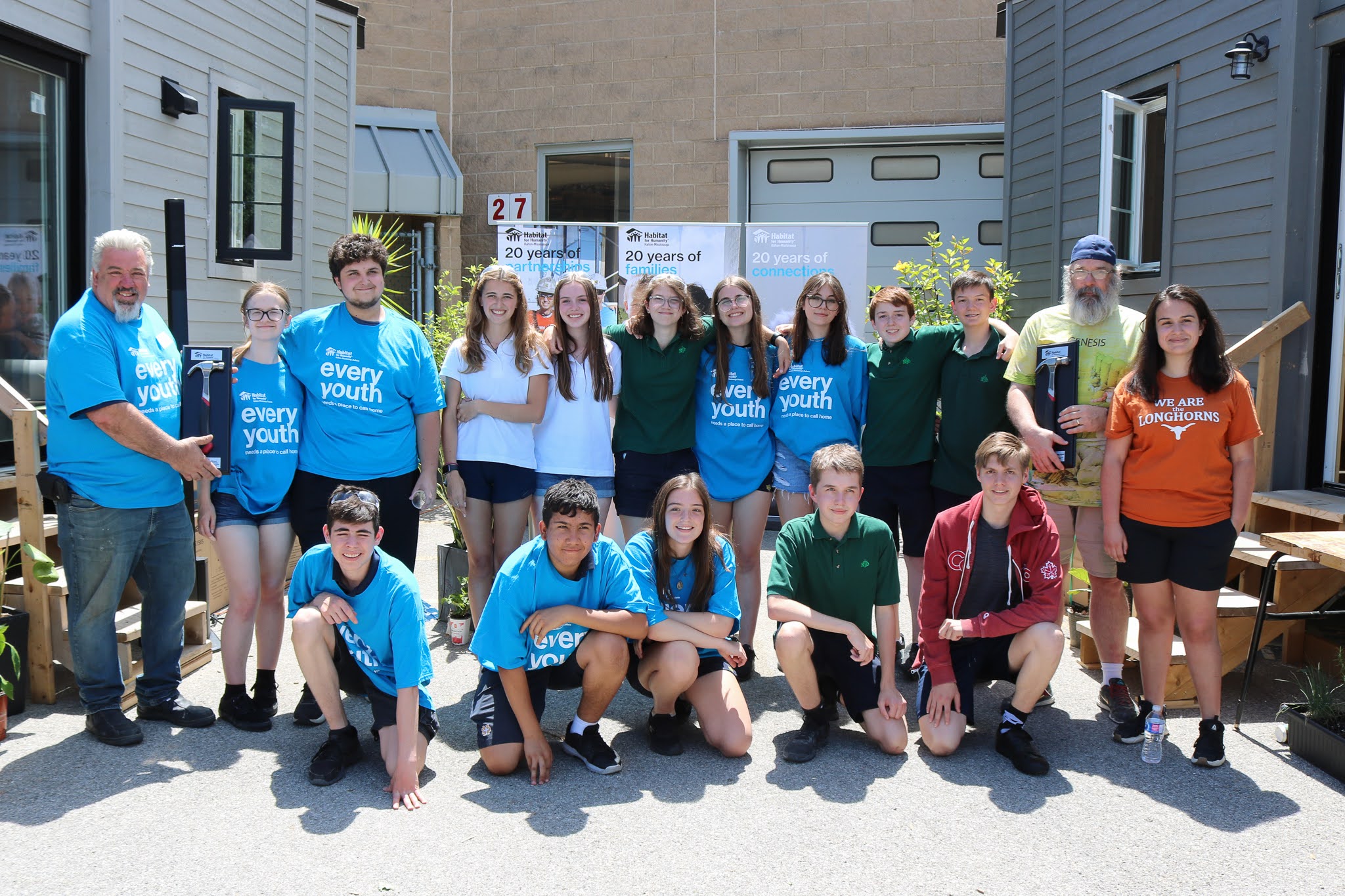 Meridian employees volunteering at a community-based tiny house build