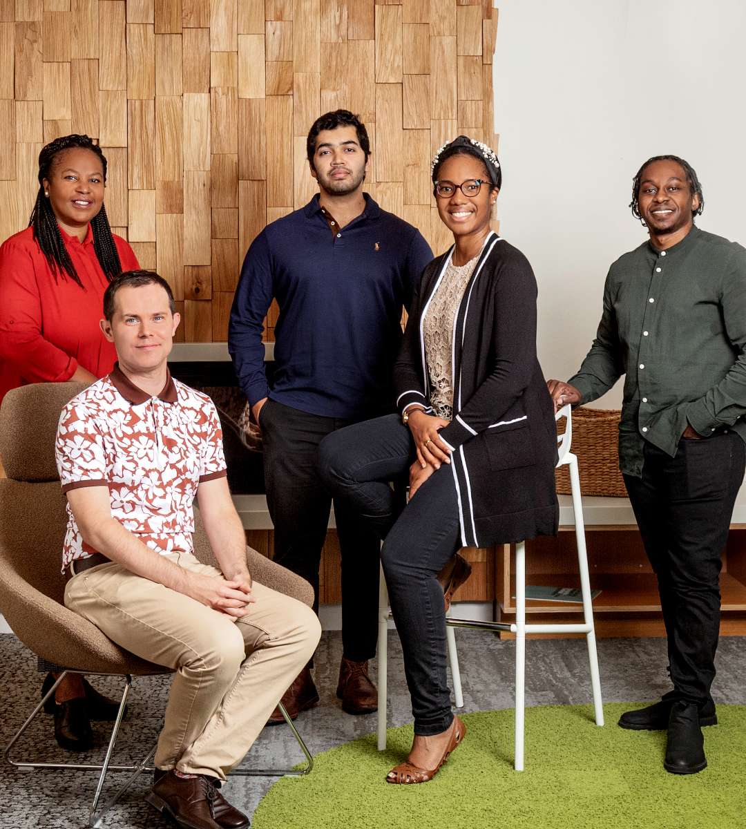 Group of five diverse office employees at work