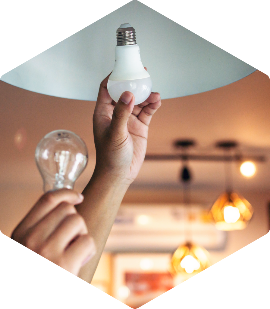 Hand replacing a lightbulb