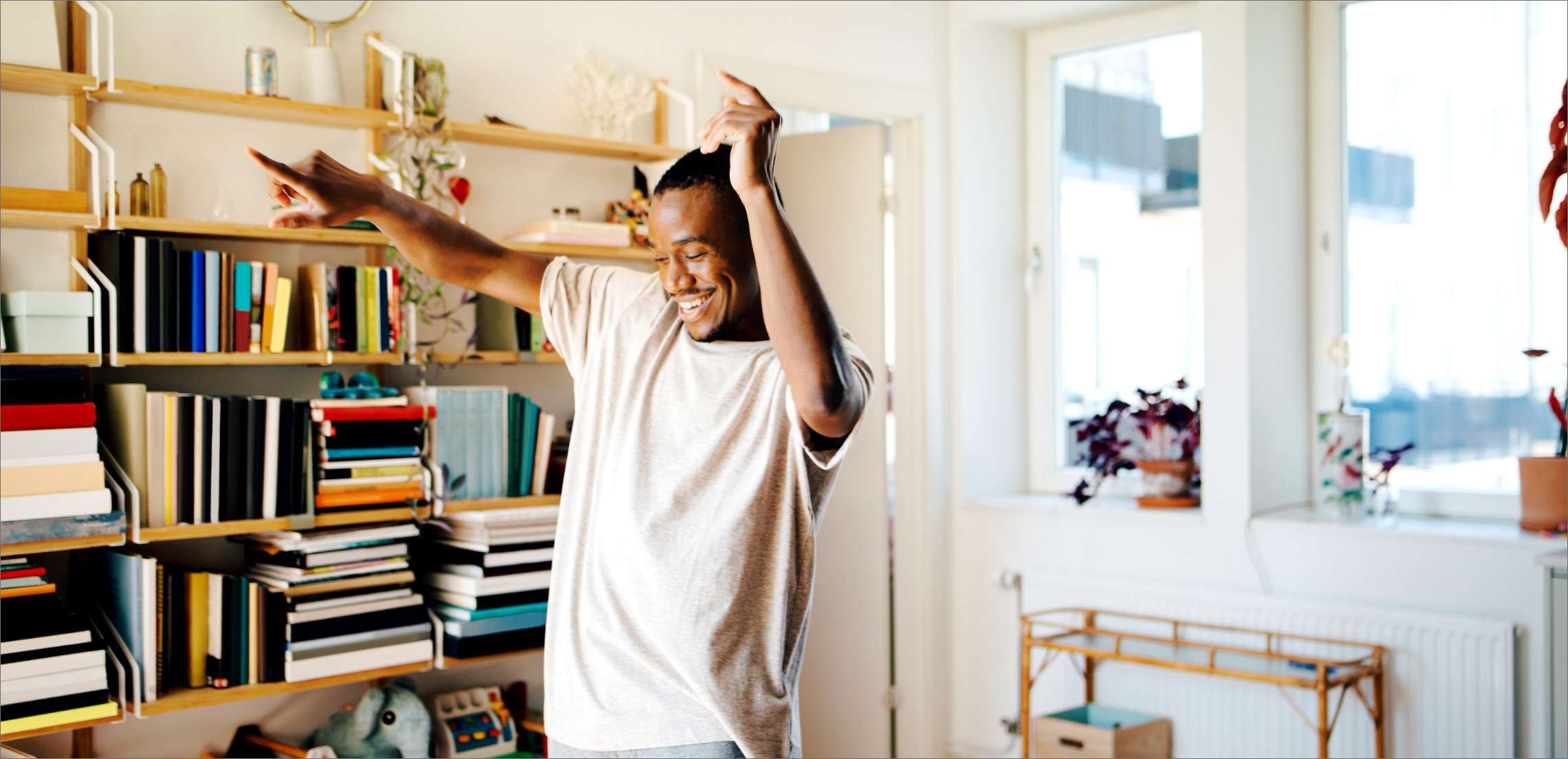 Happy man dancing in living room at home