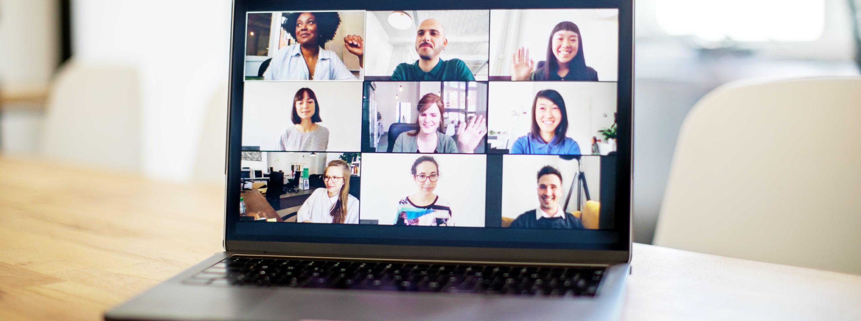 laptop showing a nine people on a Zoom call