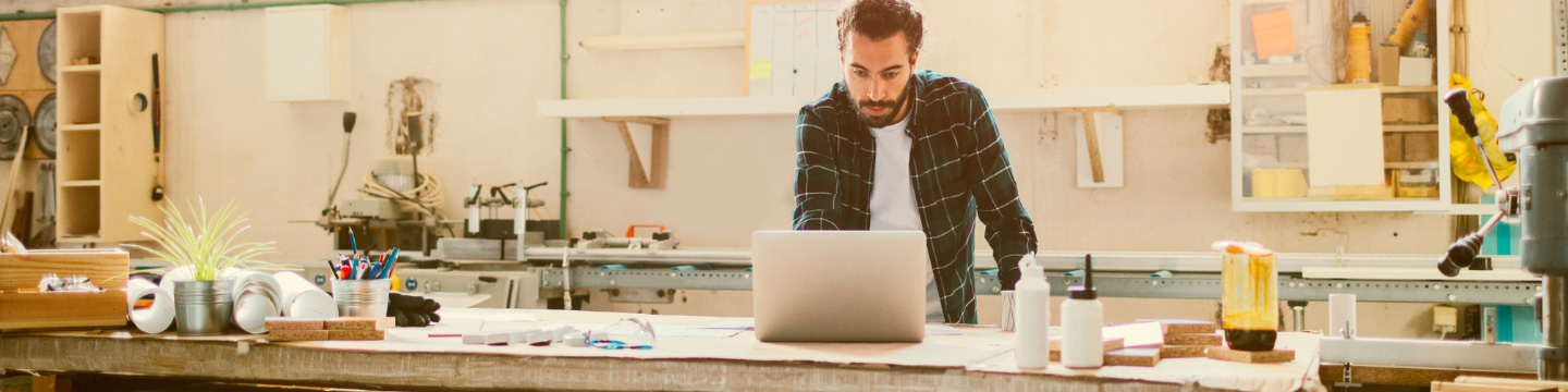 Man using a laptop in his workshop