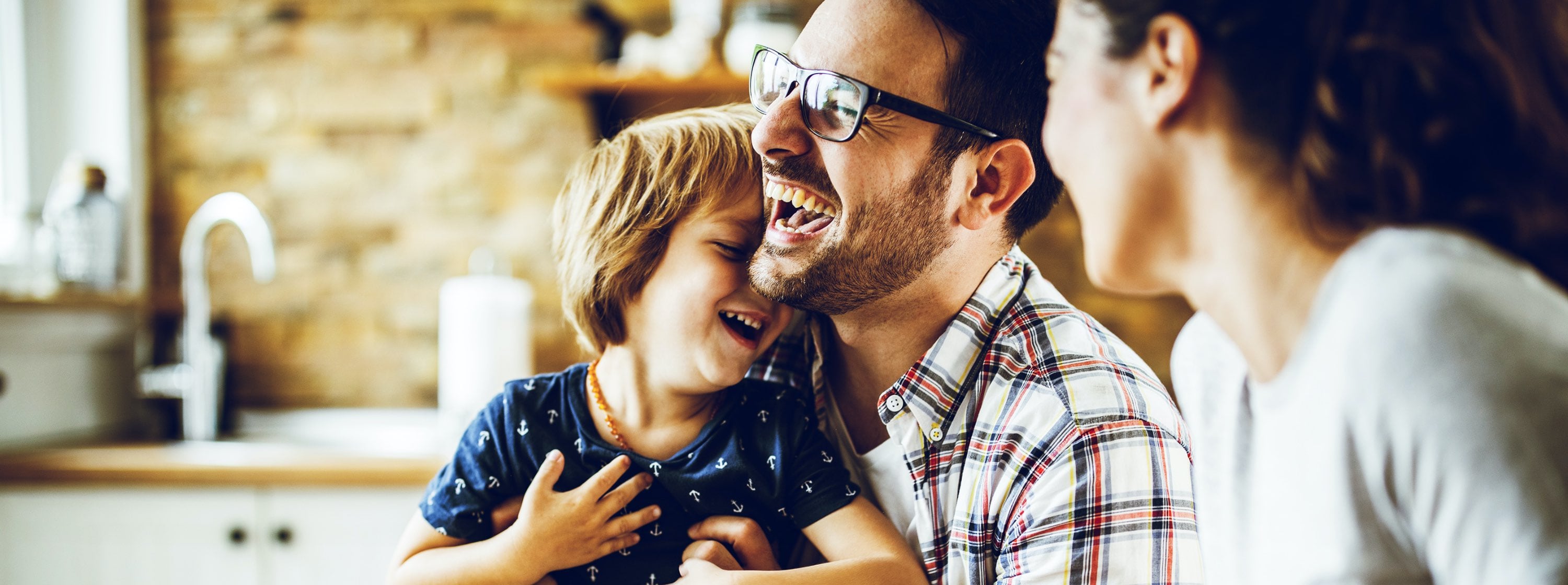 Family Laughing and smiling in their kitchen