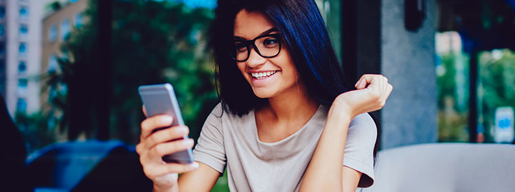 young smiling girl using her cellphone