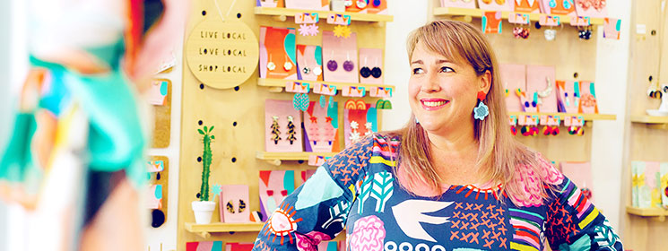 Female business owner, smiling, in her shop