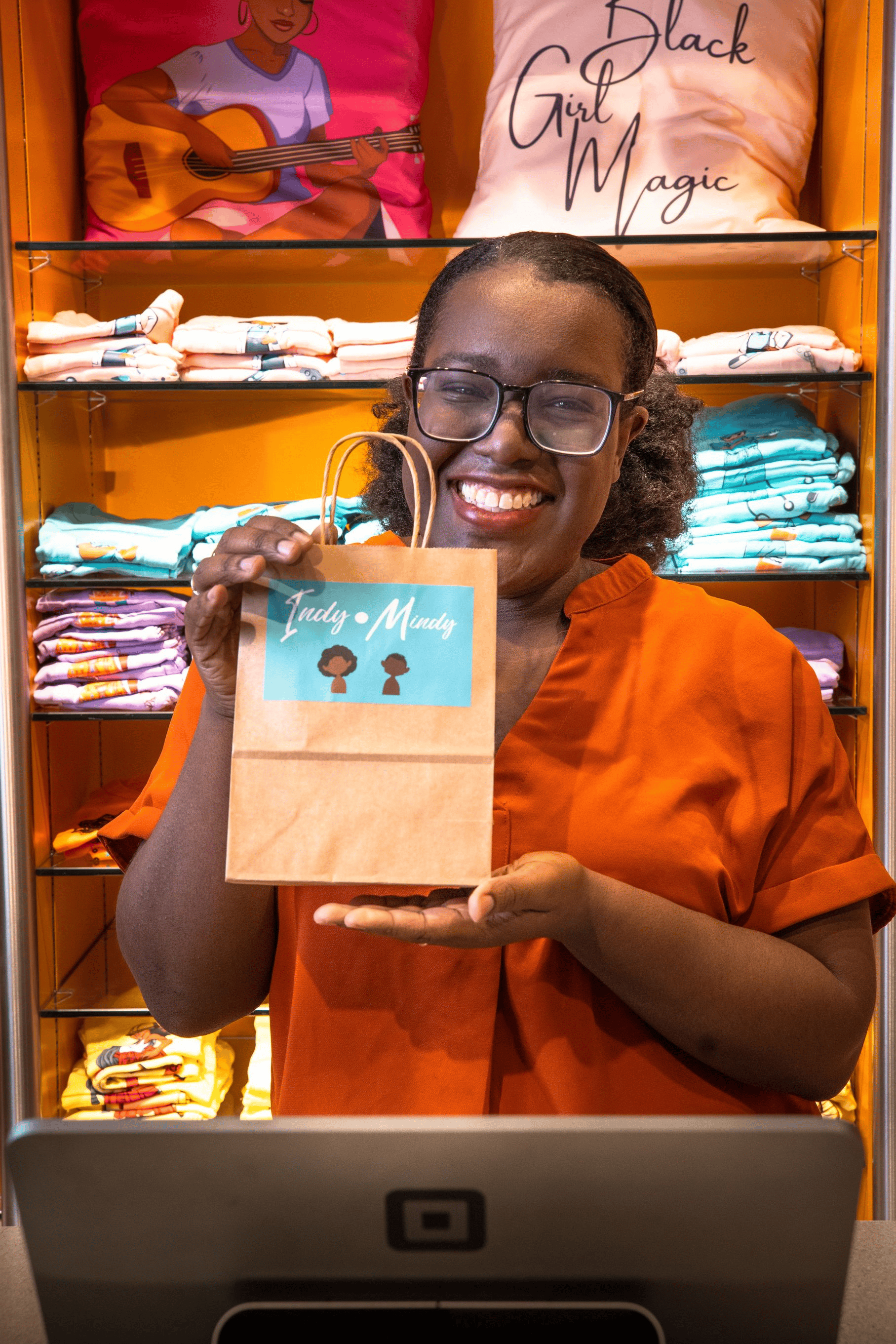 Indy Mindy co-founder Deborah Vassell holding a shopping bag with Indy Mindy logo on it