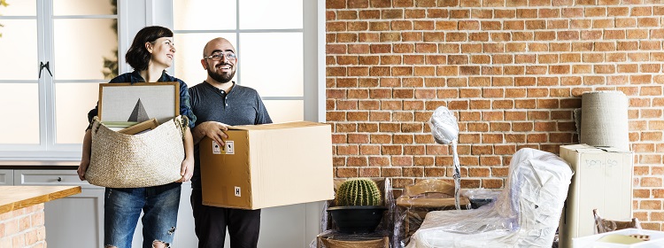 Smiling couple moving into new house