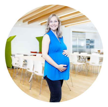 Smiling pregnant Meridian employee in staff eating area