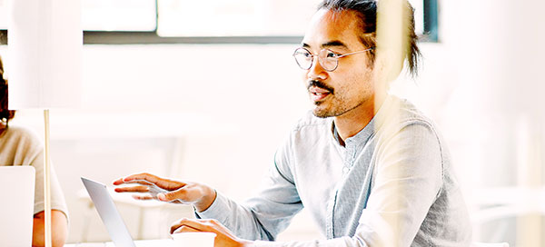 Man with laptop in a meeting