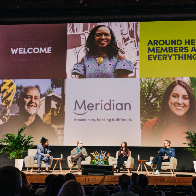 People chatting during a panel onstage at Meridian’s annual general meeting.