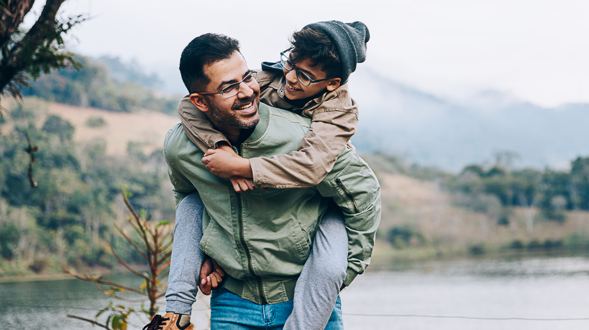 A man carrying his son on his back