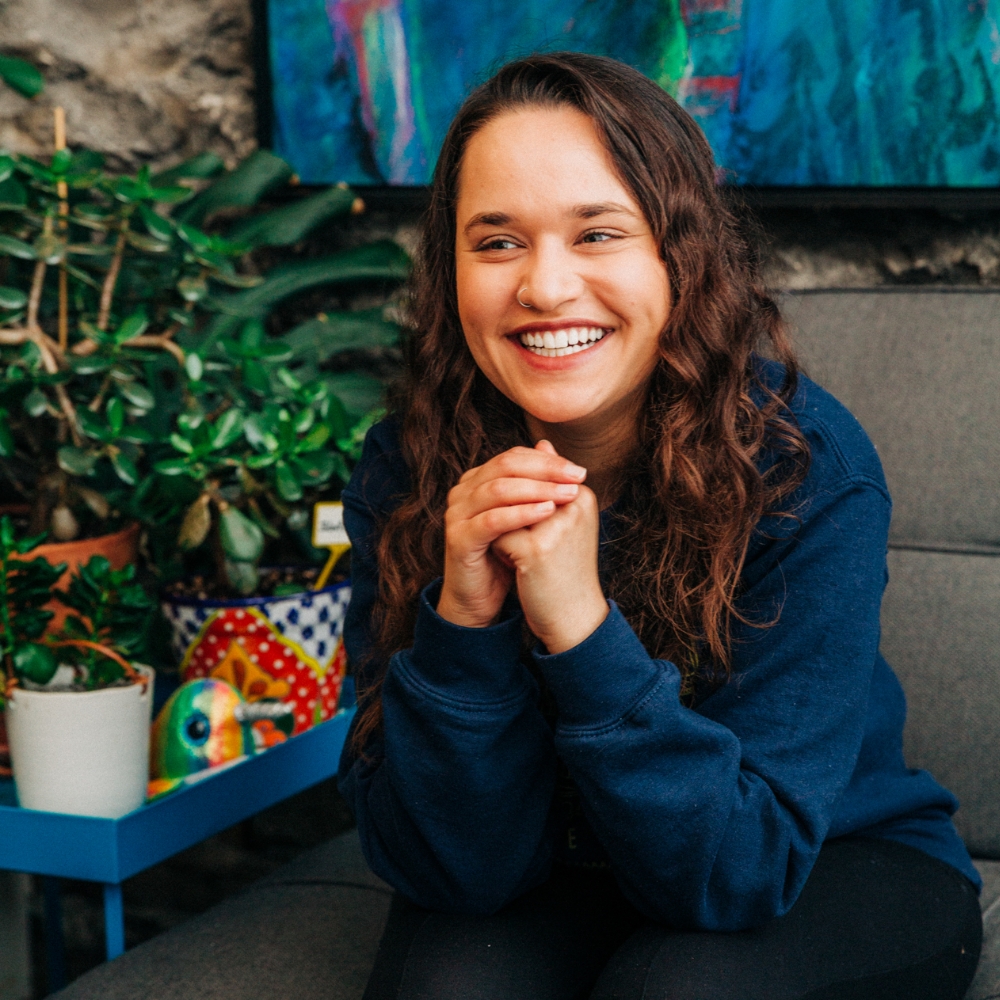 Smiling female staff member from Wellington Water Watchers. She has a medium skin tone and is wearing a blue sweatshirt. 