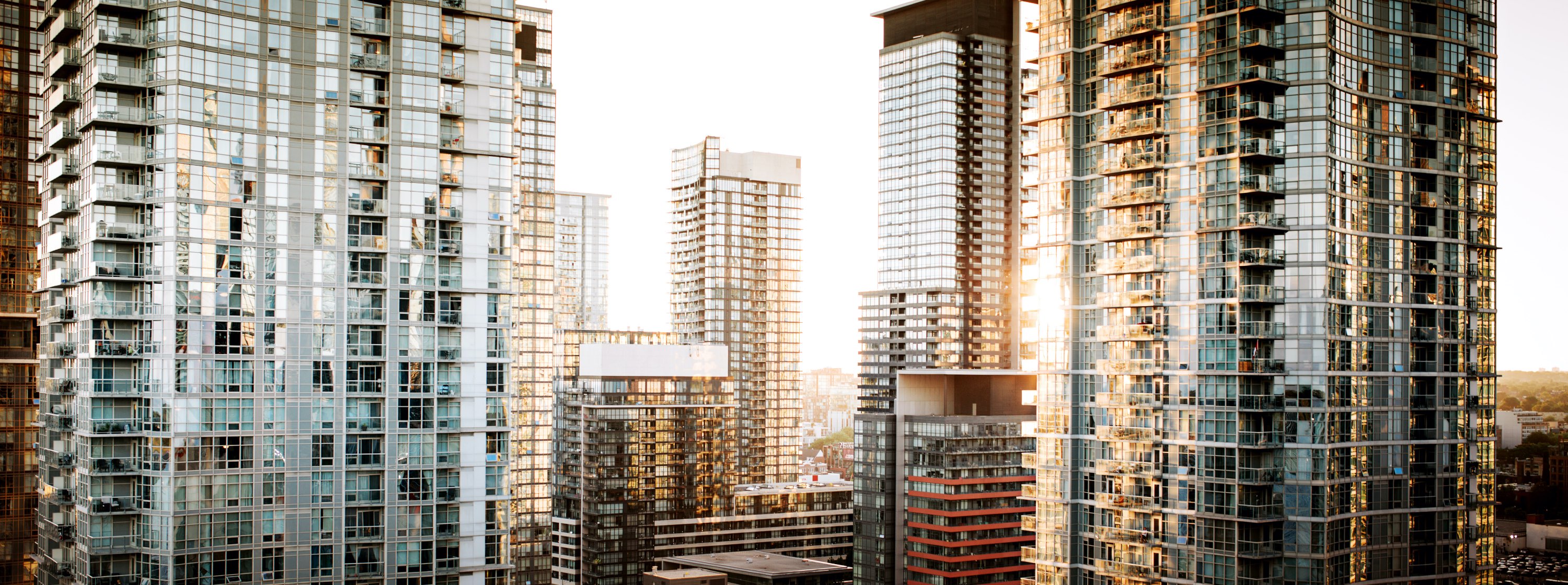 The sun reflects on a a collection of high rise buildings in Toronto