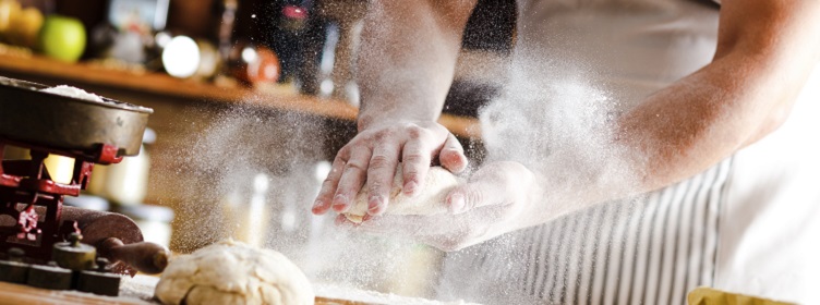 close up of hands making bread