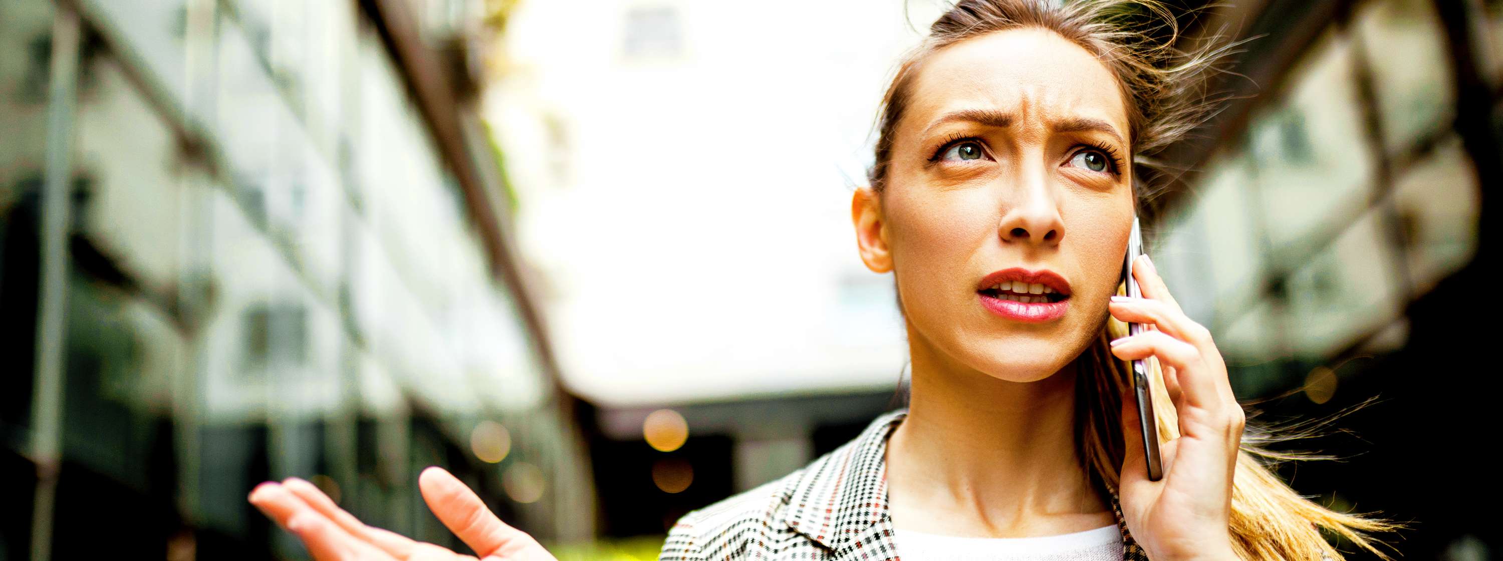 woman talking on her mobile phone with a confused face