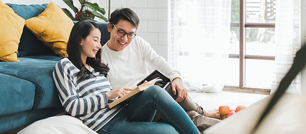 couple laughing and reading together