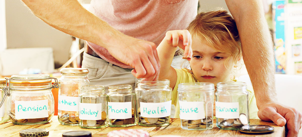 A child with different jars full of change