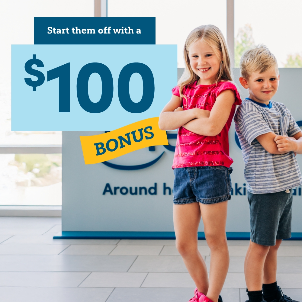 Start them off with a $100 bonus. Image of two smiling kids in a Meridian branch.