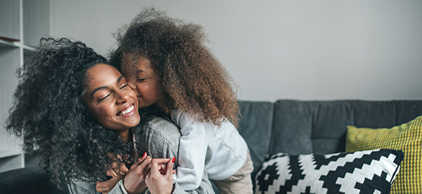 daughter kissing mom on the cheek