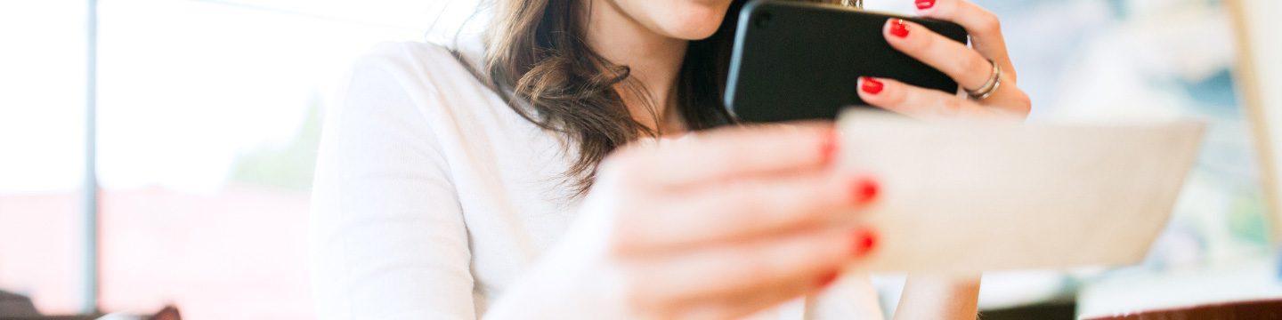 Woman taking picture of a cheque with her phone