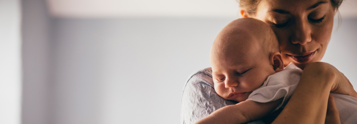 Woman holding a sleeping baby