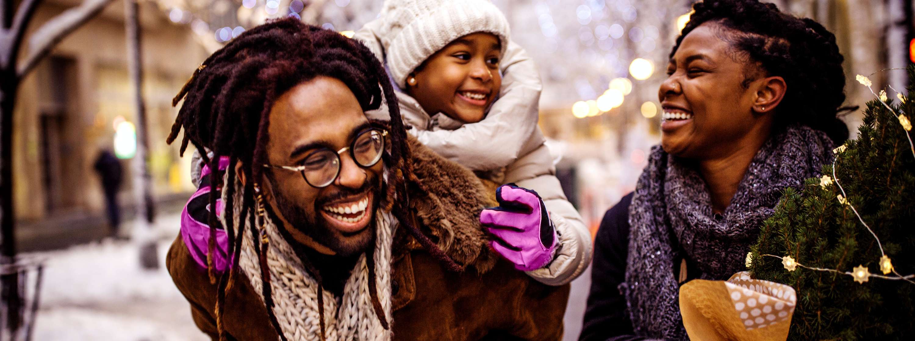 Happy family laughing outside in the snow