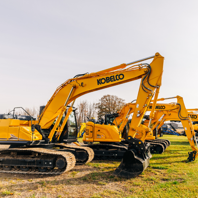A row of yellow excavator trucks. Delta Power Equipment. Meridian OneCap.