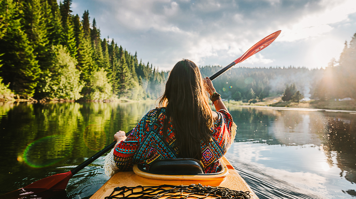 A woman kayaking on a lake